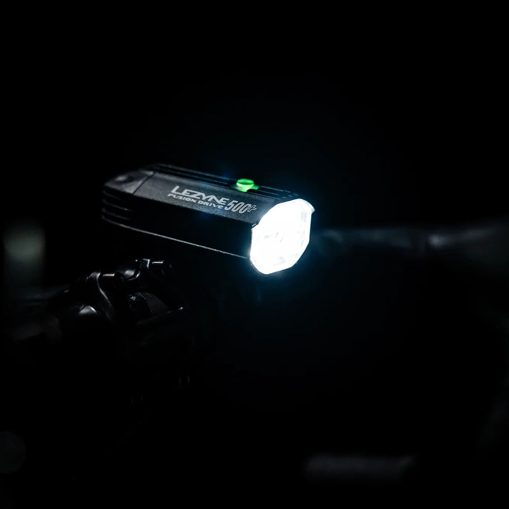The powerful beam pattern of the Lezyne Fusion Drive 500+ lighting up a trail at night.