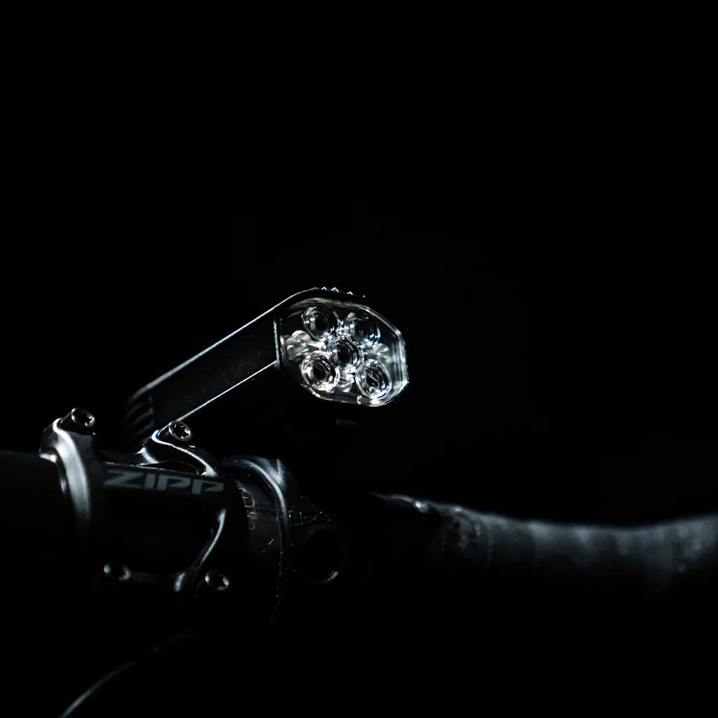 The low-profile Lezyne LED qPRO Mount securely installed on a bicycle handlebar.