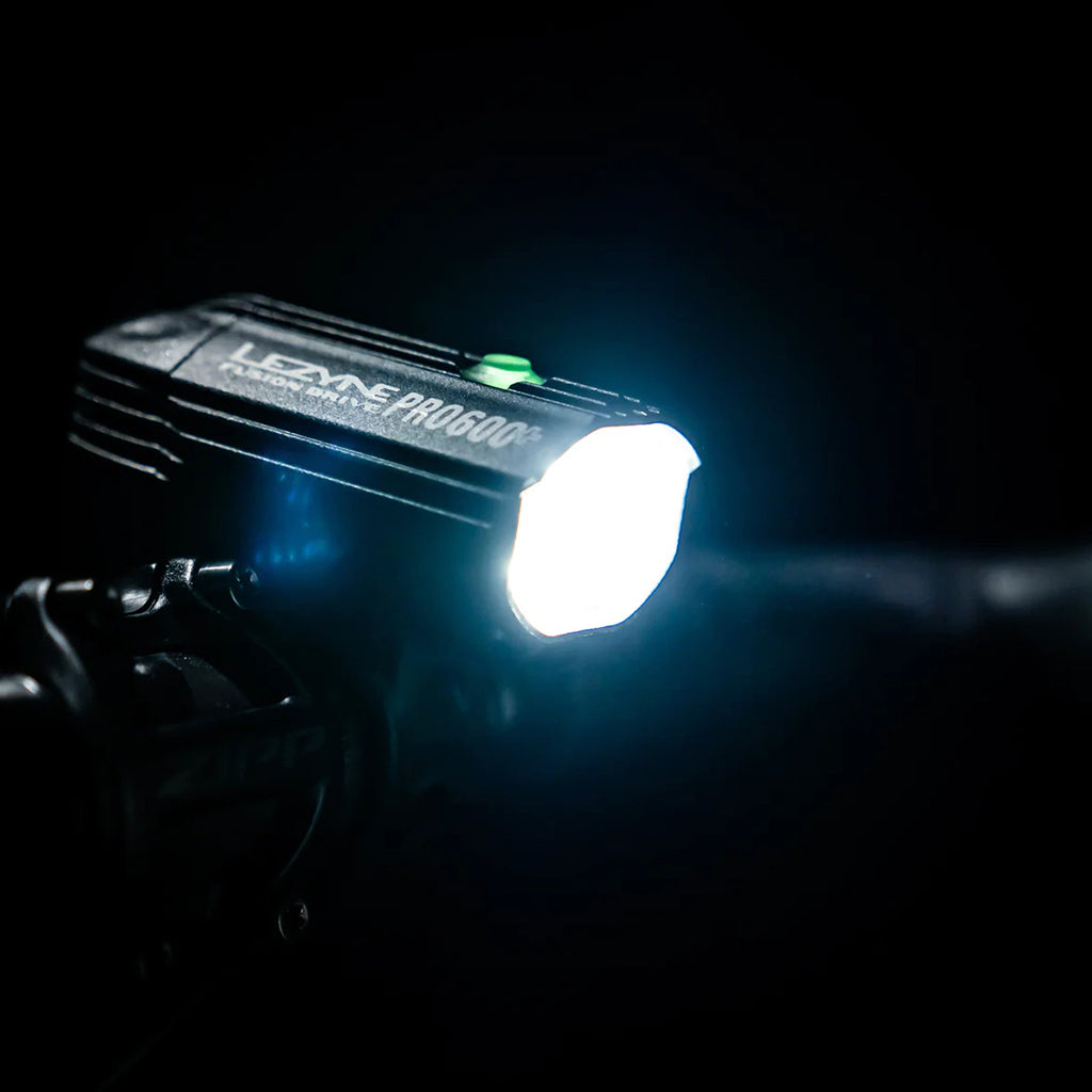 A night shot of the Lezyne Fusion Drive Pro 600+ light's powerful 600-lumen beam illuminating a dark trail.
