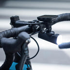 The Magicshine Garmin To GoPro Adapter is shown with both its Garmin mount side and the three-pronged GoPro interface.