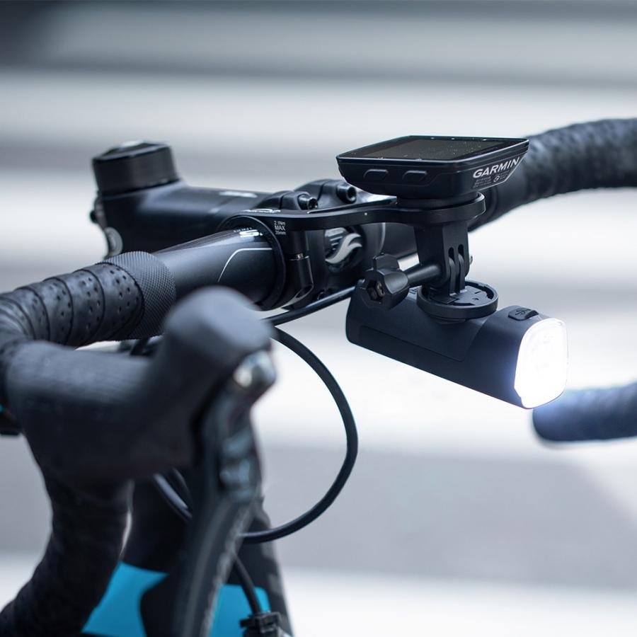 The Magicshine Garmin To GoPro Adapter is shown with both its Garmin mount side and the three-pronged GoPro interface.