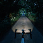 Cyclist using MAGICSHINE EVO 1100 black light, clearly visible at night