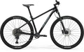 A black Merida BIG.NINE 400 hardtail mountain bike.


