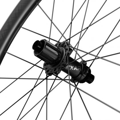 Close-up of the rear hub on the Magene EXAR Pro DB45 Carbon Wheelset, featuring a black disc brake hub with detailed spoke lacing and a sleek carbon rim