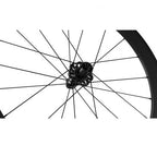 ose-up of a Magene EXAR Pro DB45 Carbon Wheelset with 45mm deep rims and disc brake compatibility, showcasing black spokes and a sleek hub design against a white background