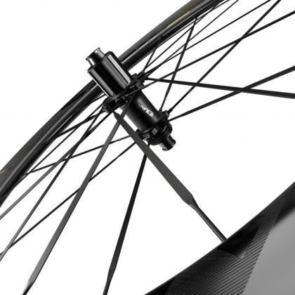 A detailed view of a Magene EXAR Ultra DB607 carbon wheel, highlighting a spoke, perfect for disc brake setups.
