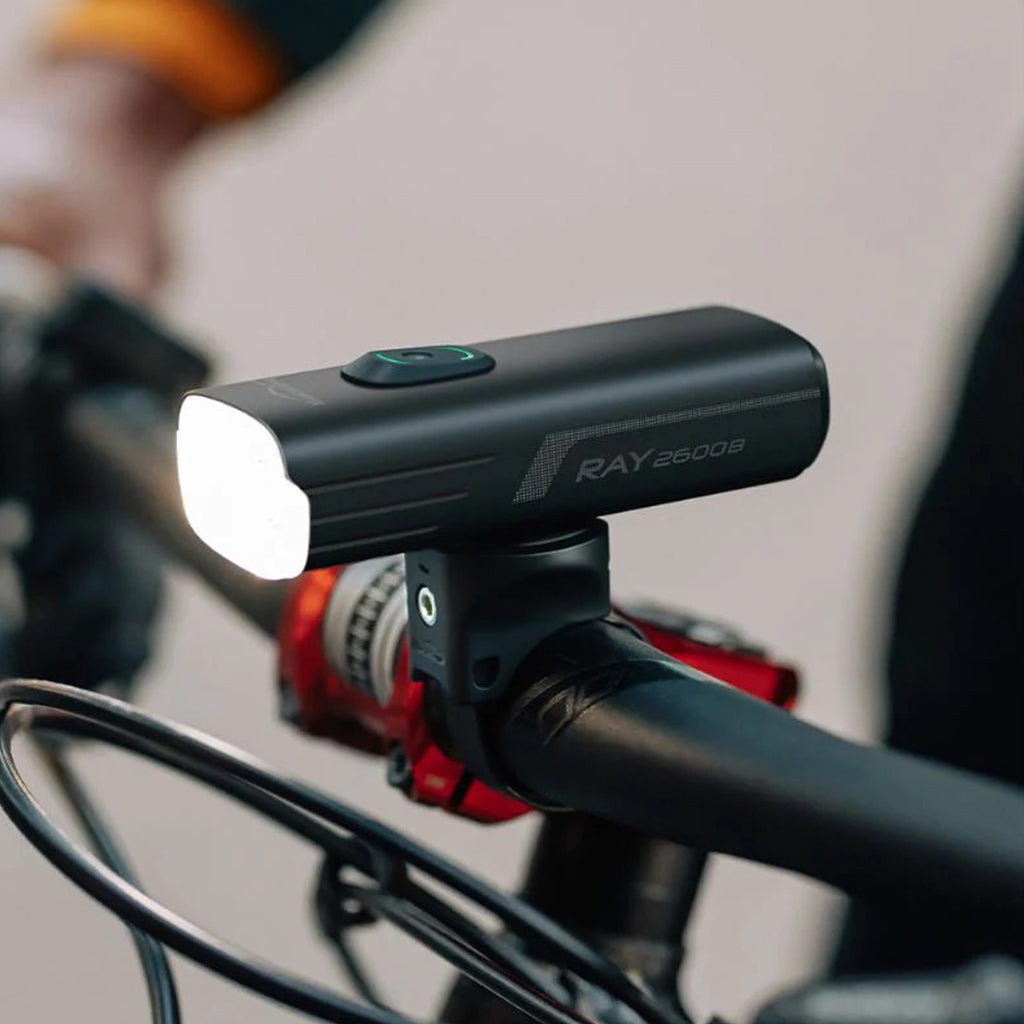 A close-up of the Magicshine RAY 2600B light's USB-C port, showing it being used for charging or as a power bank.