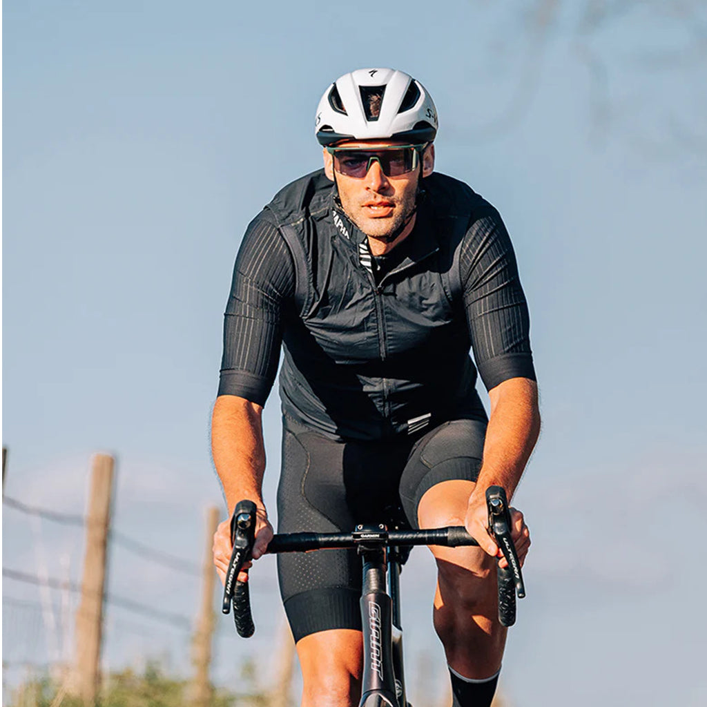 Person engaging in outdoor activity, wearing Magicshine Rouler Photochromic Sports Sunglasses-Lake Blue, showcasing the blend of style, safety, and adaptive vision.