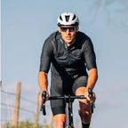 Person engaging in outdoor activity, wearing Magicshine Rouler Photochromic Sports Sunglasses-Lake Blue, showcasing the blend of style, safety, and adaptive vision.