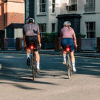 View from behind a cyclist using the Magicshine SEEMEE 100AD tail light, showing its powerful 100-lumen flash ensuring presence and reducing collision risks.