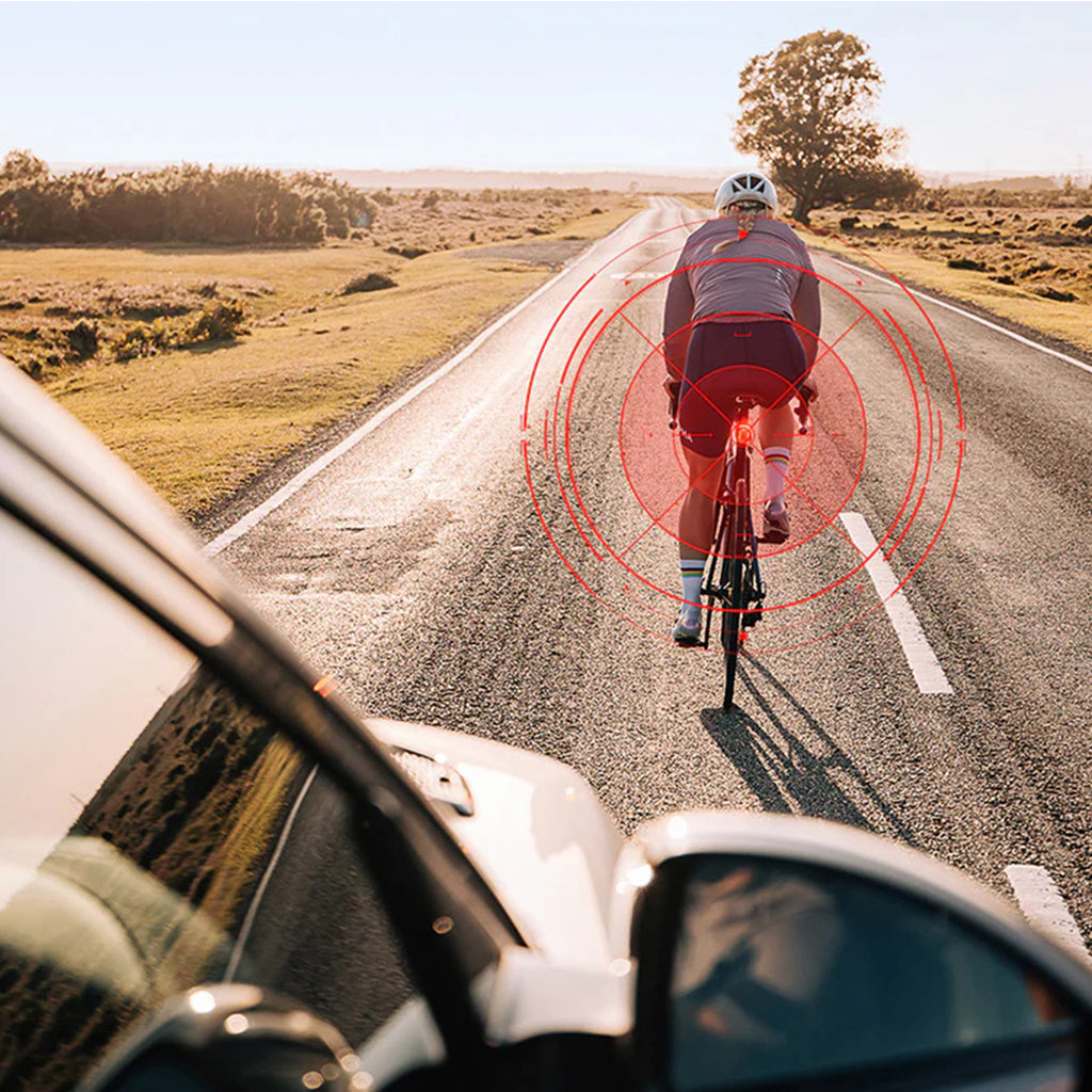 Magicshine SEEMEE 100AD Radar Rear Light on a bike in city traffic, demonstrating its ability to alert cyclists to both silent electric bicycles and fast-moving cars.
