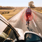 Magicshine SEEMEE 100AD Radar Rear Light on a bike in city traffic, demonstrating its ability to alert cyclists to both silent electric bicycles and fast-moving cars.