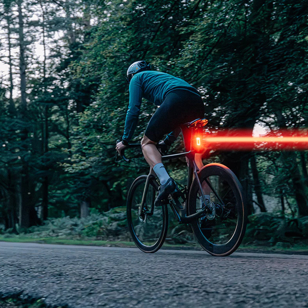 Magicshine SEEMEE 100AD Smart Rear Light mounted on a bicycle, providing crucial rear visibility and automatic alerts for safer rides on busy urban roads.