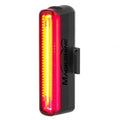 The Magicshine SEEMEE 30TL V2.0 rear light illuminated, showing its bright red rectangular light and yellow central strip