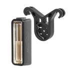 A rectangular Magicshine SEEMEE rear light shown next to a black V-shaped mount with two arms.