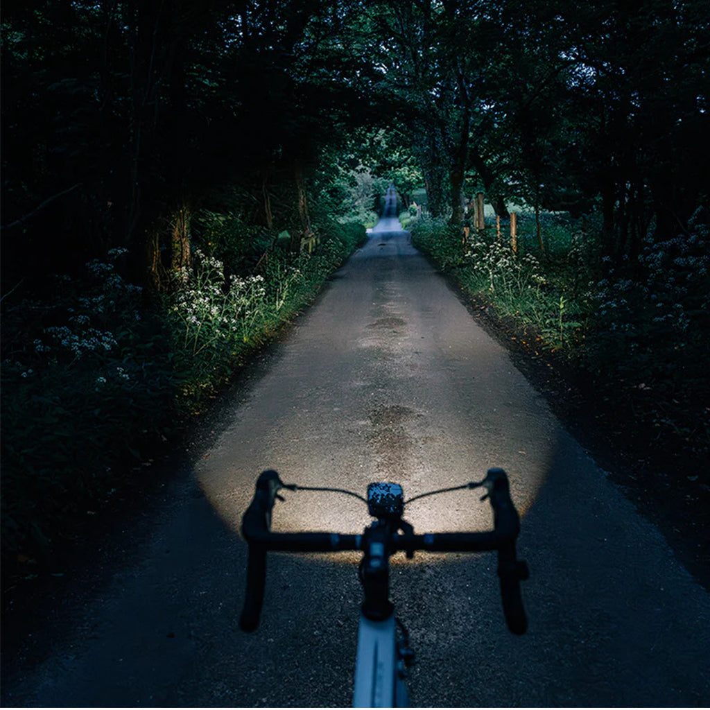 Magicshine EVO 1100 front bike light in sleek black design, visible at night