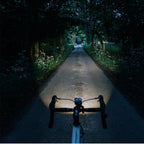 Magicshine EVO 1100 front bike light in sleek black design, visible at night