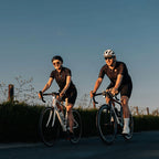  Two cyclists ride on a road, with the Magicshine EVO 1700 light visible on the front bike.