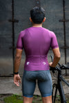 A man showing back side of purple colored maximus podium-fit cycling jersey