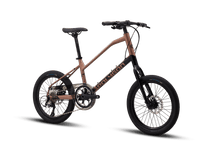 Side view of a Polygon Zeta 2 city bike in a metallic bronze finish, featuring disc brakes.
