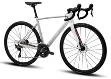 Full side view of a white Polygon Strattos S5 Disc road bike with black components and subtle colored accents on the fork and frame, against a light background.