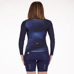Santini Ombra Eco Sleek Long Sleeve Jersey in blue, from the rear, on a hanger, clearly showing the extended back panel for coverage in the riding position and the form-fitting design for aerodynamic efficiency.