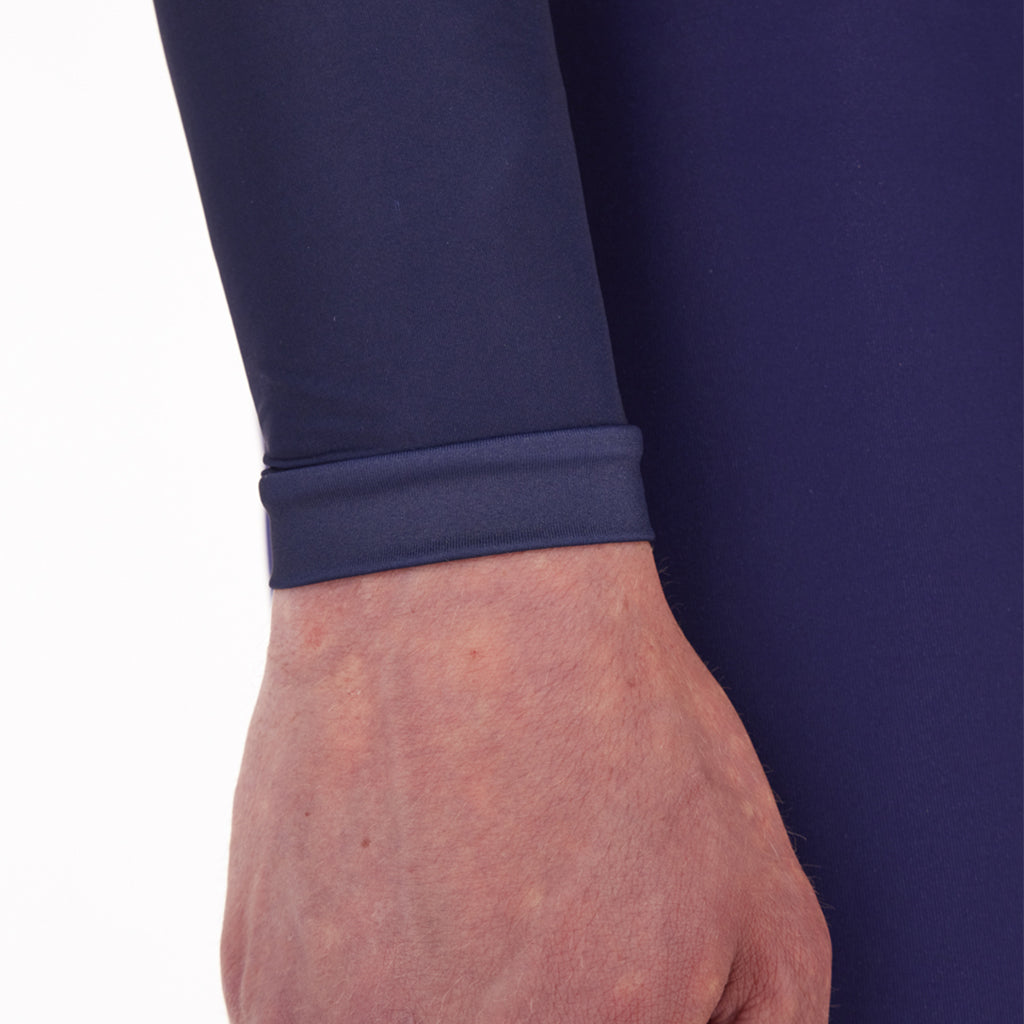 Cyclist wearing the Santini Ombra blue long sleeve jersey, showcasing its aerodynamic sleek fit and extra sun protection for arms