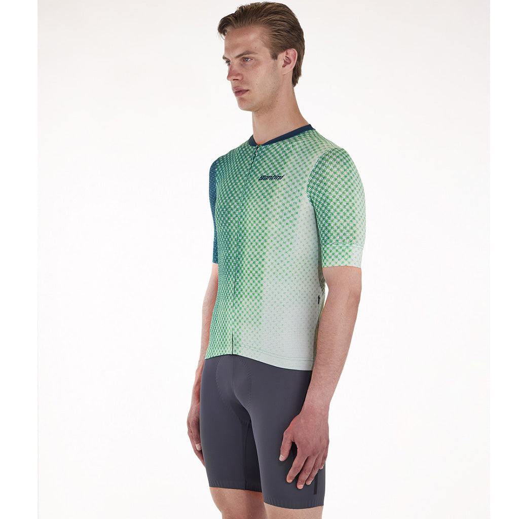 Cyclist wearing the Santini Paws Teal jersey, showcasing its slim fit and reflective details for high visibility.