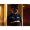 Cyclist wearing the Santini Pirelli Sport Club black jersey, showcasing its UPF50+ protection and suitability for long rides.