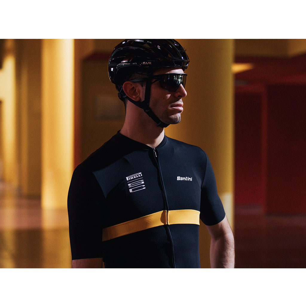Cyclist wearing the Santini Pirelli Sport Club black jersey, showcasing its UPF50+ protection and suitability for long rides.