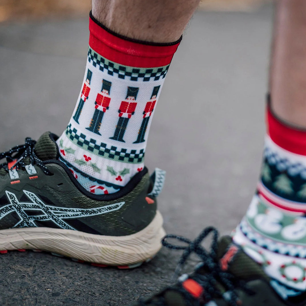 Holiday themed sports socks with nutcracker and candy cane design
