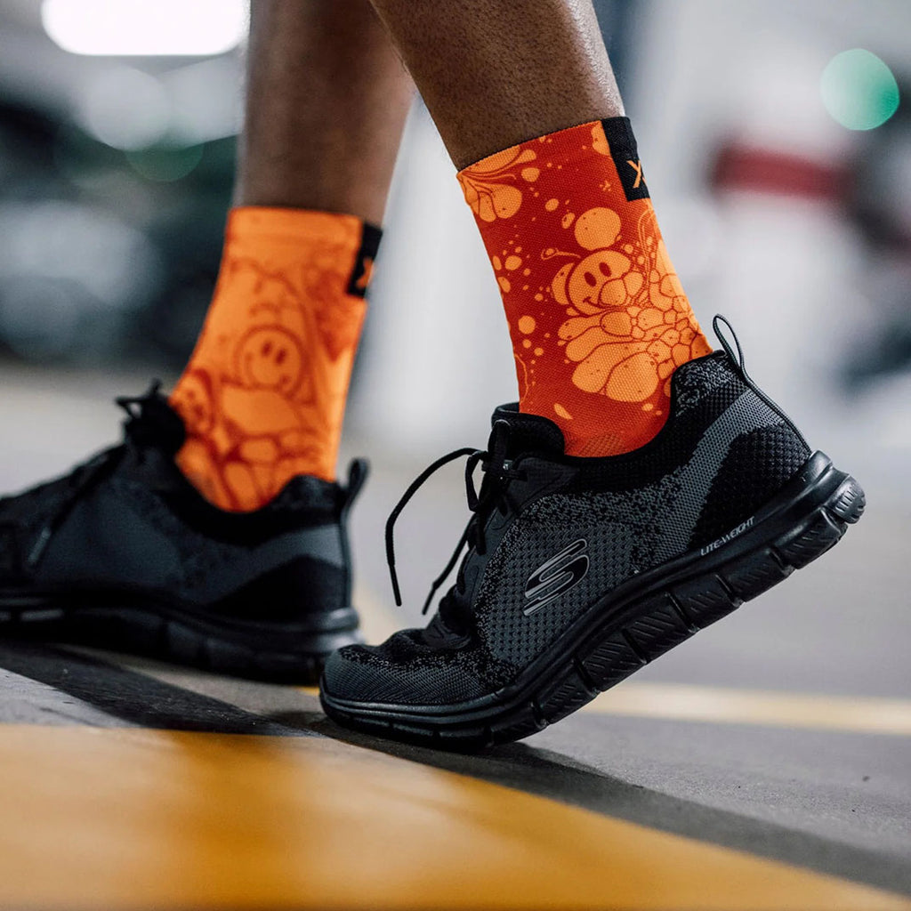 Neon orange Sox crew socks with smiley swirl design