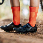 Lightweight orange athletic crew socks with breathable mesh fabric