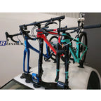 Car roof equipped with a bicycle rack holding a bike, showcasing the TreeFrog 9QR-15X100mm Thru Axle Fork Mount Bracket.
