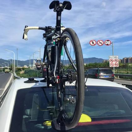  A bicycle positioned atop a car, highlighting the TreeFrog Elite 1 Bike Rack, ideal for road and gravel biking
