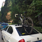  A bicycle positioned atop a car, highlighting the TreeFrog Elite 1 Bike Rack, ideal for road and gravel biking