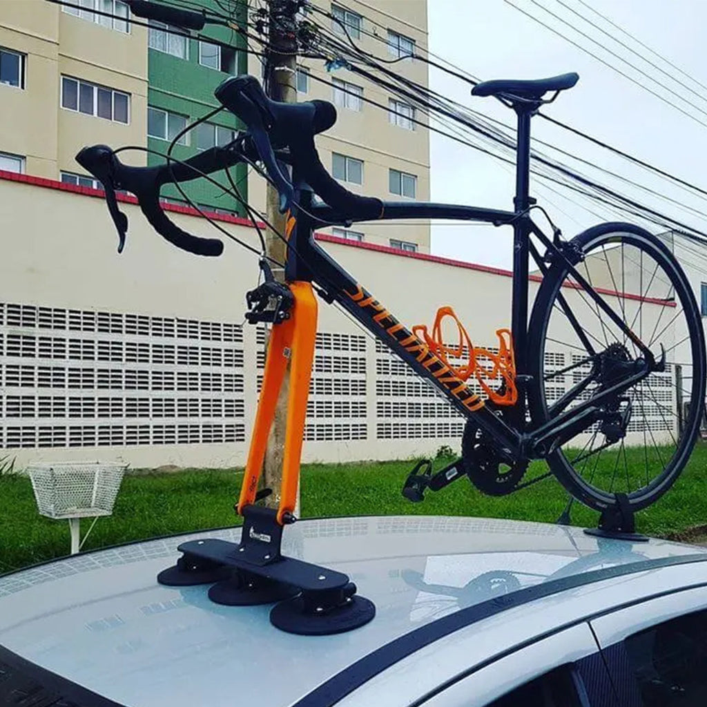  A bicycle mounted on a car roof rack, featuring the TreeFrog Elite 1 Bike Rack, ideal for road and gravel biking