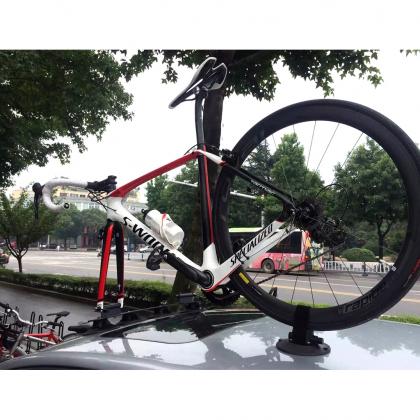  A bicycle rests on a car, secured by the TreeFrog Elite 2 Bike Rack, designed for road and gravel bikes.
