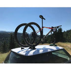 A bike secured on a car's roof rack, featuring the TreeFrog L1 Front Wheel Holder for easy transport