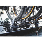 A car featuring a bike mounted on its roof with a TreeFrog L2 Front Wheel Holder for secure transport