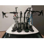  A car with a TreeFrog L2 bike rack on top, holding two bikes securely in place. Perfect for outdoor adventures