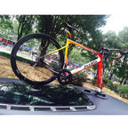 A bicycle rests on a car, showcasing the TreeFrog Pro 1 bike rack designed for road and mountain bikes