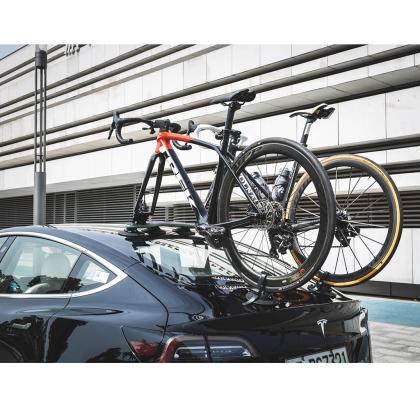 A bicycle rests on a car's bike rack, showcasing the TreeFrog Pro 2, perfect for road and mountain biking adventures