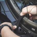  A person securing a bike wheel on the TreeFrog Pro 2 Bike Rack.