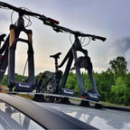 Two bikes on a car's roof rack, highlighting the TreeFrog Pro 3 Bike Rack, perfect for road and mountain biking adventures.

