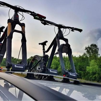  Two bikes on a car's roof rack, highlighting the TreeFrog Pro 3 Bike Rack, perfect for road and mountain biking adventures.

