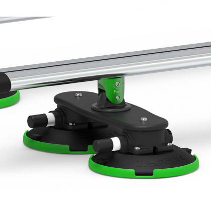  Two green and black plastic table holders next to silver TREEFROG roof rack crossbars.
