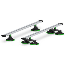 Two green and black car racks with black wheels, featuring TREEFROG ROOF RACK CROSSBARS in silver.