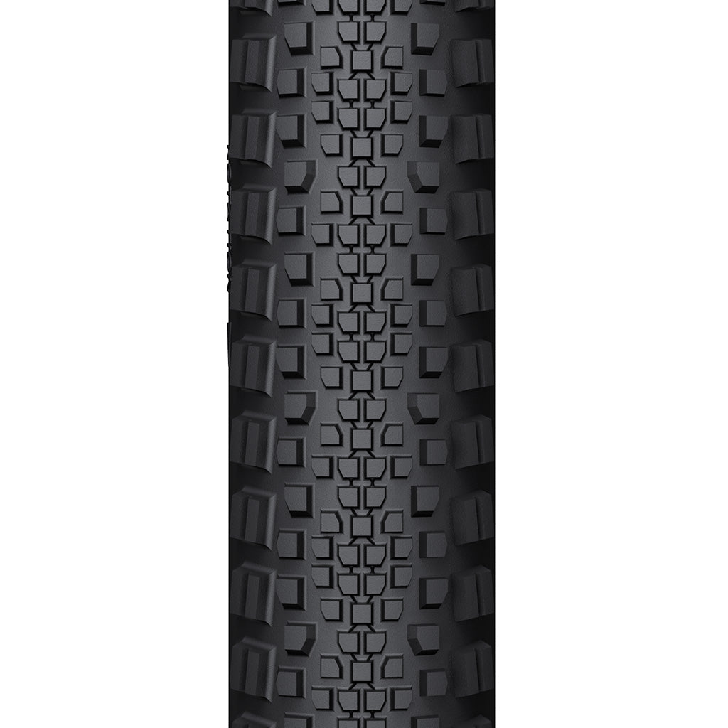 A close-up of the WTB Riddler tire, showing its light/fast rolling tread pattern and classic tanwall finish.

