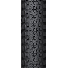 A close-up of the WTB Riddler tire, showing its light/fast rolling tread pattern and classic tanwall finish.

